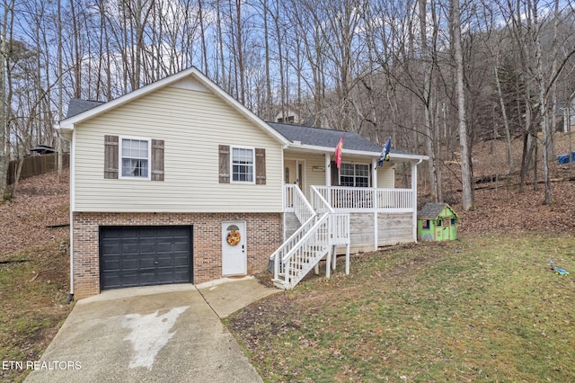 view of front of property with stairway, driveway, covered porch, a garage, and brick siding