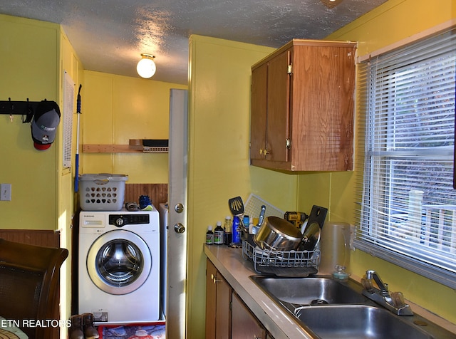 laundry area with washer / clothes dryer, sink, and a textured ceiling