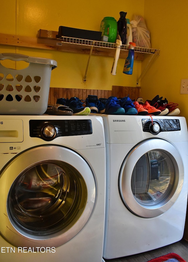 clothes washing area with separate washer and dryer