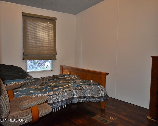 bedroom featuring dark wood-type flooring