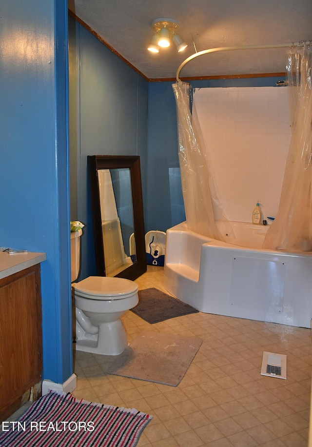 full bathroom featuring vanity, shower / tub combo, and toilet