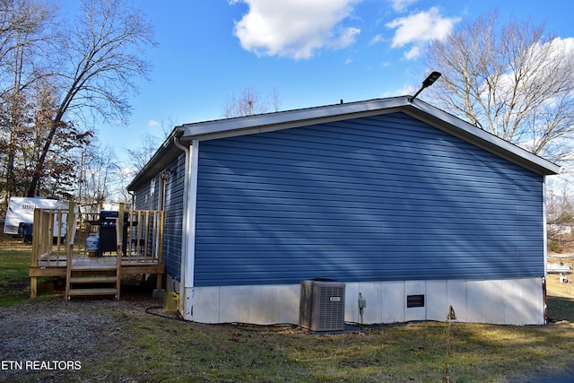 view of property exterior with a wooden deck, a yard, and central air condition unit