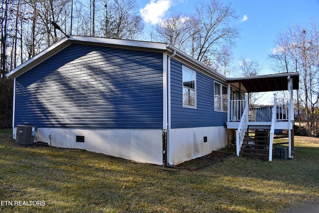 view of home's exterior with a yard and central air condition unit