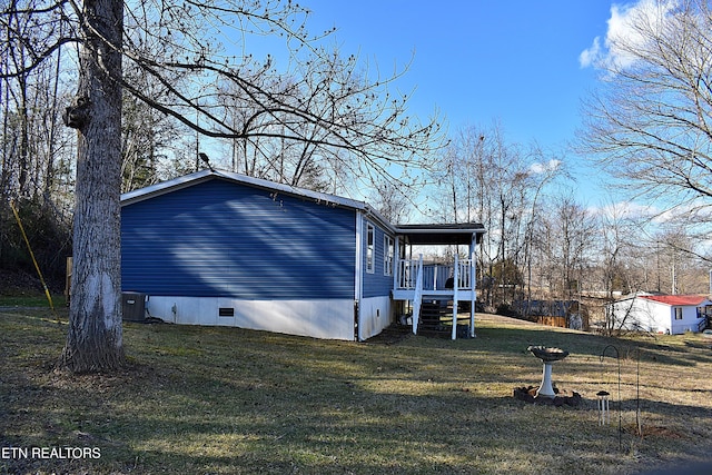 view of home's exterior with central AC and a lawn