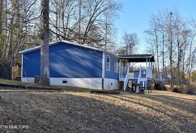 view of side of property featuring central AC and a lawn