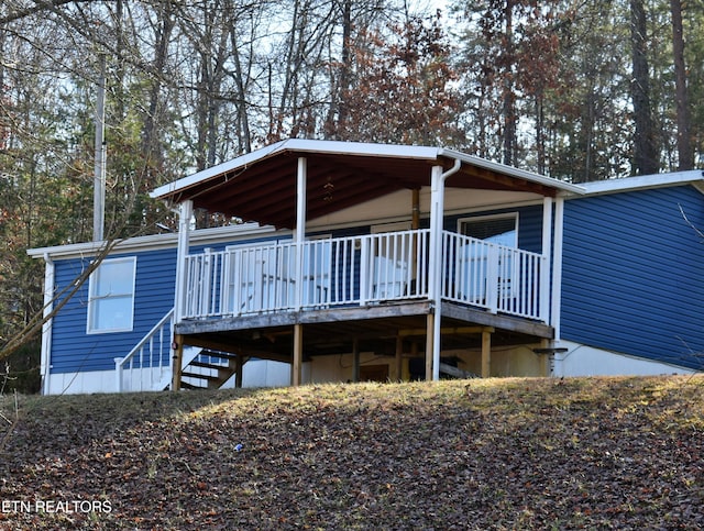 back of property with a wooden deck