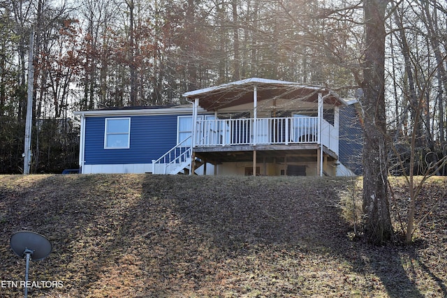 view of front of property featuring a wooden deck