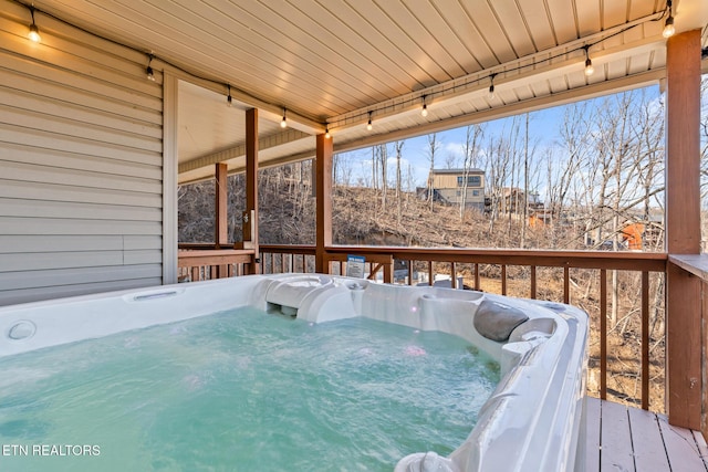 wooden terrace with a hot tub