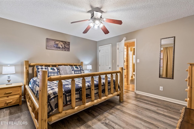 bedroom with ceiling fan, wood-type flooring, and a textured ceiling