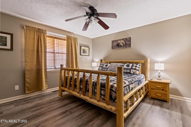 bedroom with ceiling fan, dark wood-type flooring, and a textured ceiling