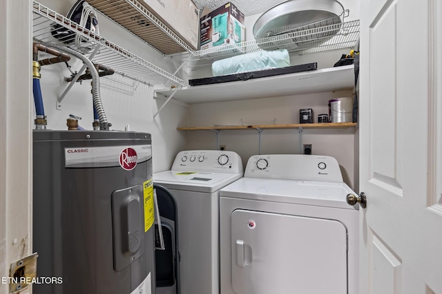 laundry area with electric water heater and washer and dryer