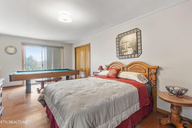 bedroom featuring crown molding, pool table, and light hardwood / wood-style flooring