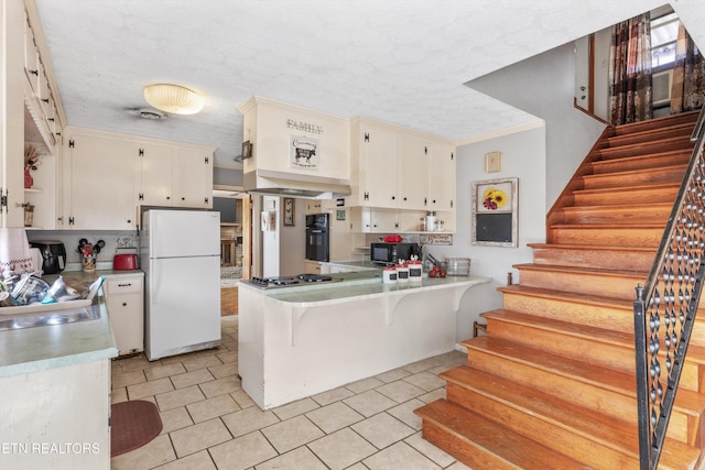 kitchen with white cabinetry, ornamental molding, black appliances, and kitchen peninsula