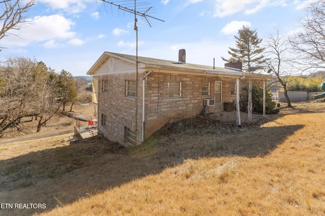 view of side of property with cooling unit and a lawn