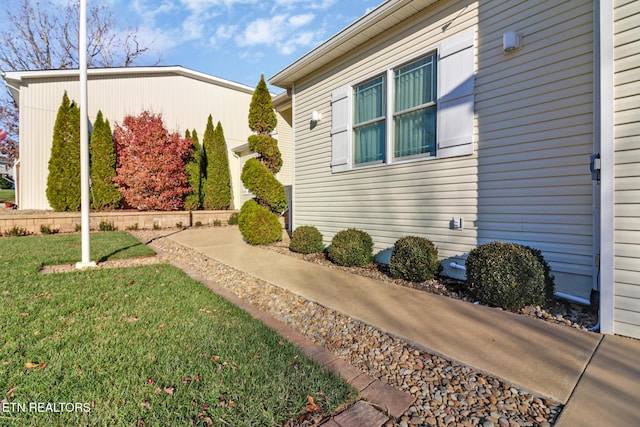 view of side of home featuring a lawn