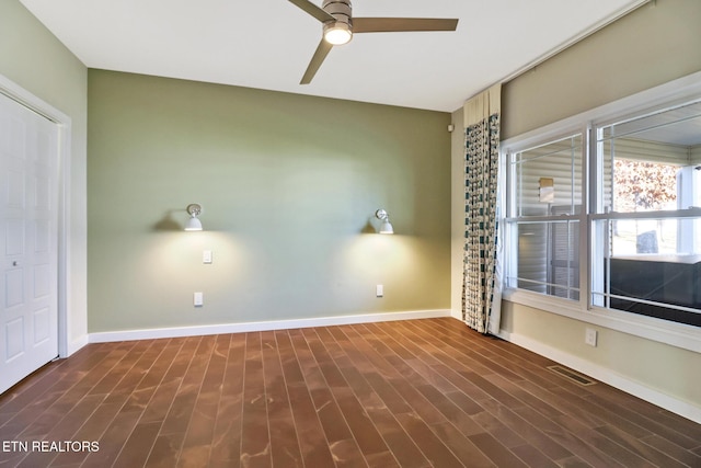 unfurnished room featuring dark wood-type flooring and ceiling fan