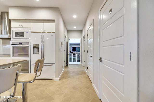 kitchen with white cabinets and white appliances