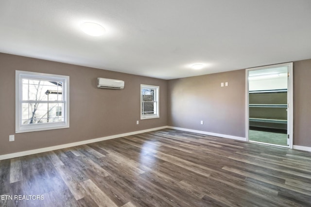 empty room with dark hardwood / wood-style floors and an AC wall unit