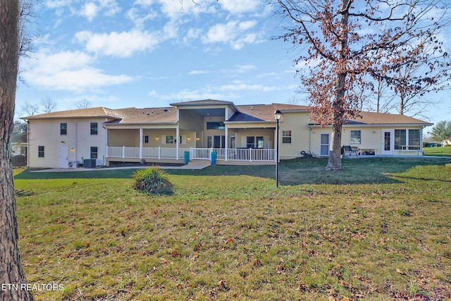 rear view of house with a lawn and central air condition unit