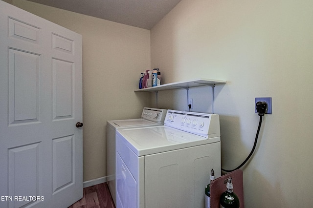 laundry area with hardwood / wood-style flooring and separate washer and dryer