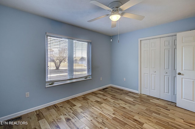 unfurnished bedroom featuring a closet, ceiling fan, and light hardwood / wood-style flooring