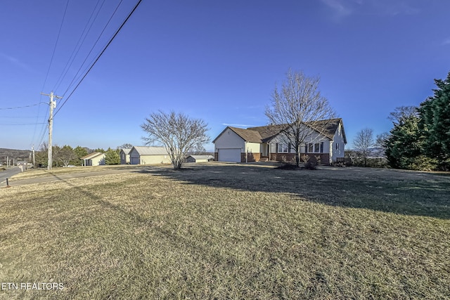 single story home featuring a garage and a front yard