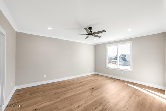 spare room with crown molding, ceiling fan, and light wood-type flooring