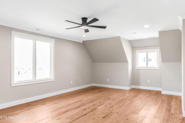 additional living space with vaulted ceiling, ceiling fan, and light hardwood / wood-style flooring