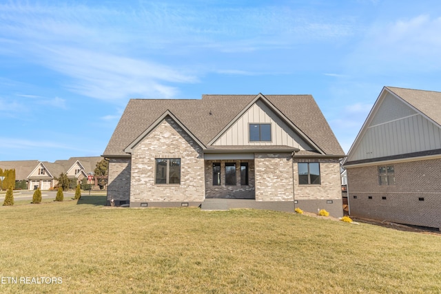 back of property featuring a lawn