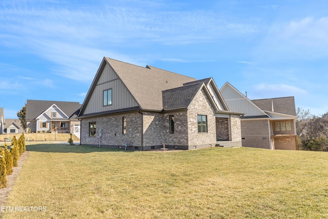 rear view of house featuring a yard