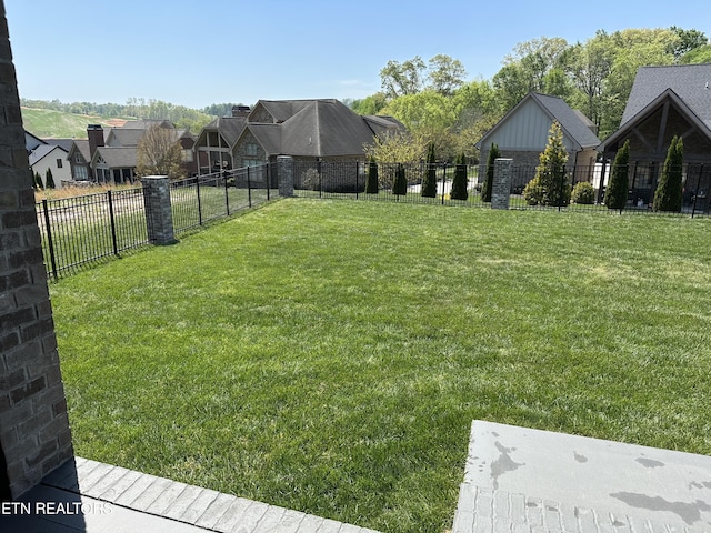view of yard with fence and a residential view