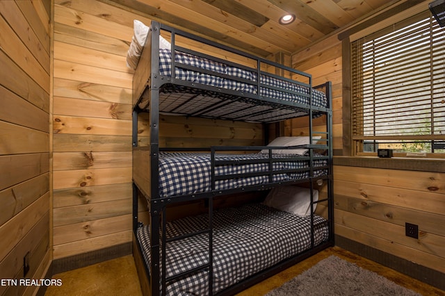 bedroom featuring wood ceiling and wood walls