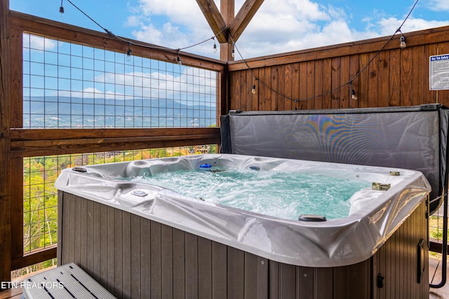 exterior space featuring a hot tub and a water view