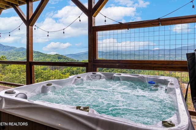 exterior details with a jacuzzi and a mountain view