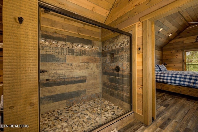 bathroom with hardwood / wood-style flooring, lofted ceiling, and wooden walls