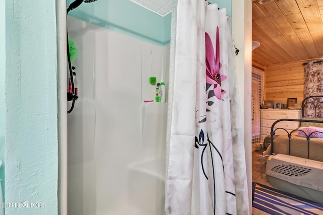 bathroom with wood ceiling, wooden walls, and curtained shower