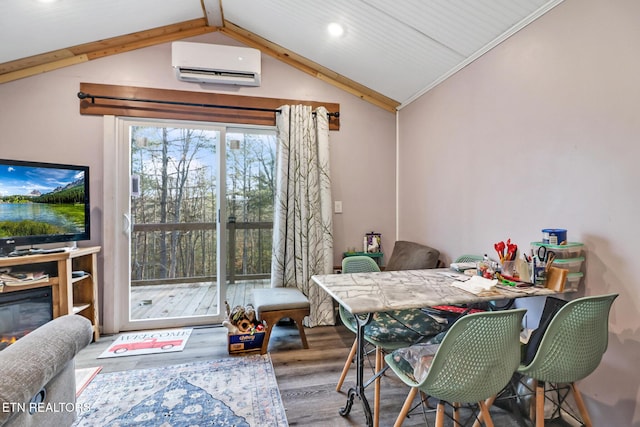 dining area with lofted ceiling with beams, an AC wall unit, and hardwood / wood-style floors