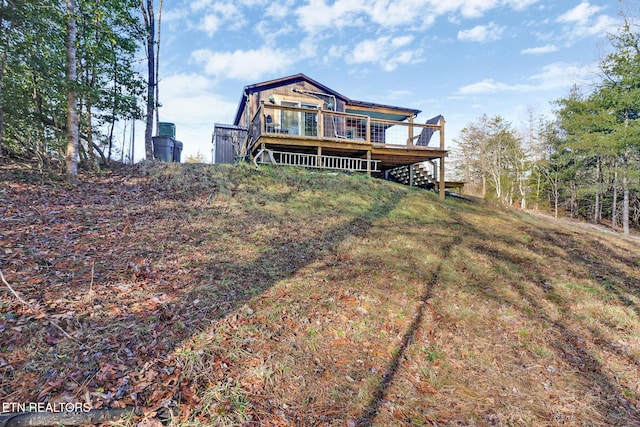 back of property featuring a deck