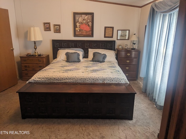 bedroom with ornamental molding and carpet