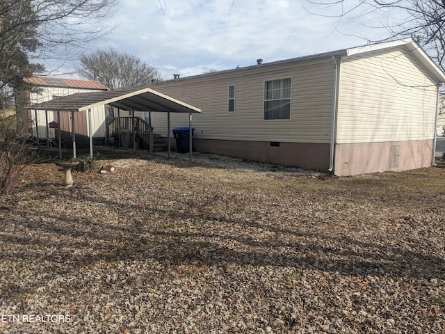 rear view of property with a carport