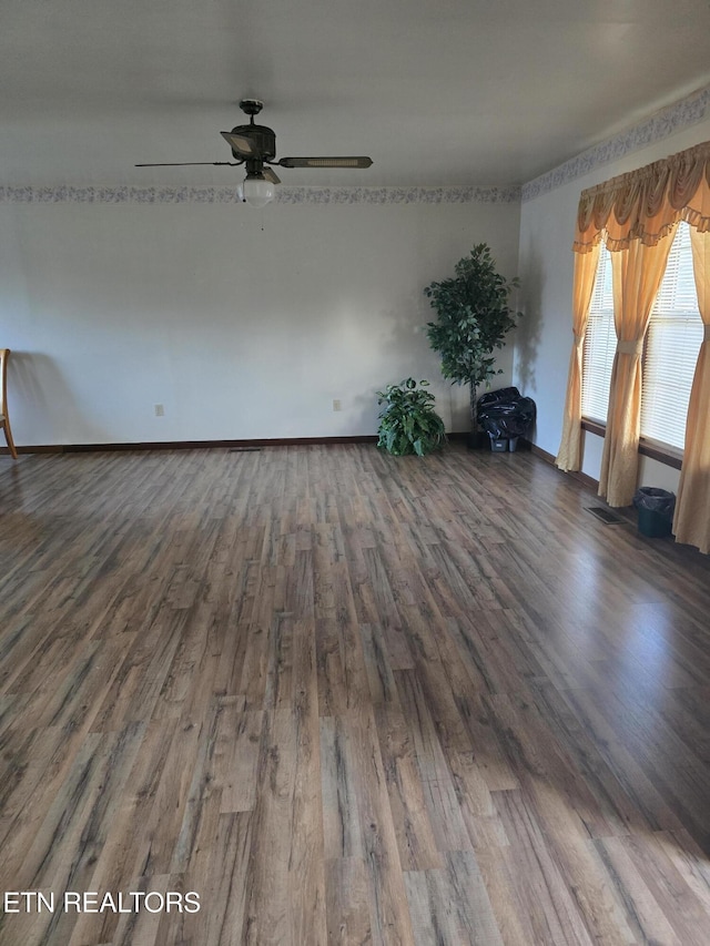 empty room featuring dark hardwood / wood-style floors and ceiling fan