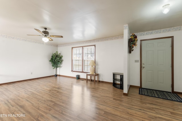 interior space with ceiling fan and wood-type flooring