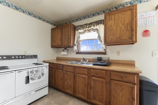 kitchen featuring white range with electric cooktop and sink