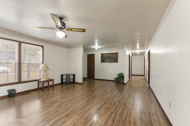 spare room featuring ceiling fan and dark hardwood / wood-style flooring