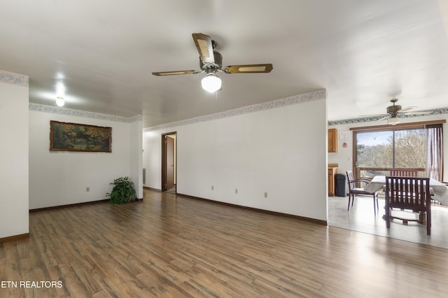 spare room featuring dark hardwood / wood-style flooring and ceiling fan