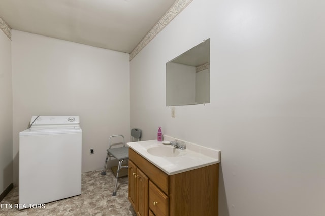 bathroom with vanity and washer / clothes dryer