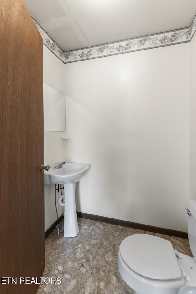 bathroom featuring sink and toilet