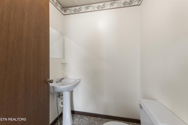 bathroom featuring toilet and sink