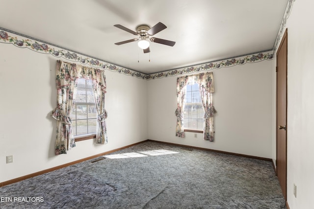 carpeted spare room with plenty of natural light and ceiling fan