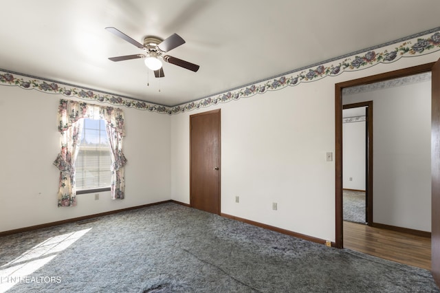 unfurnished room featuring ceiling fan and dark carpet